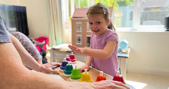 child learning music with bells